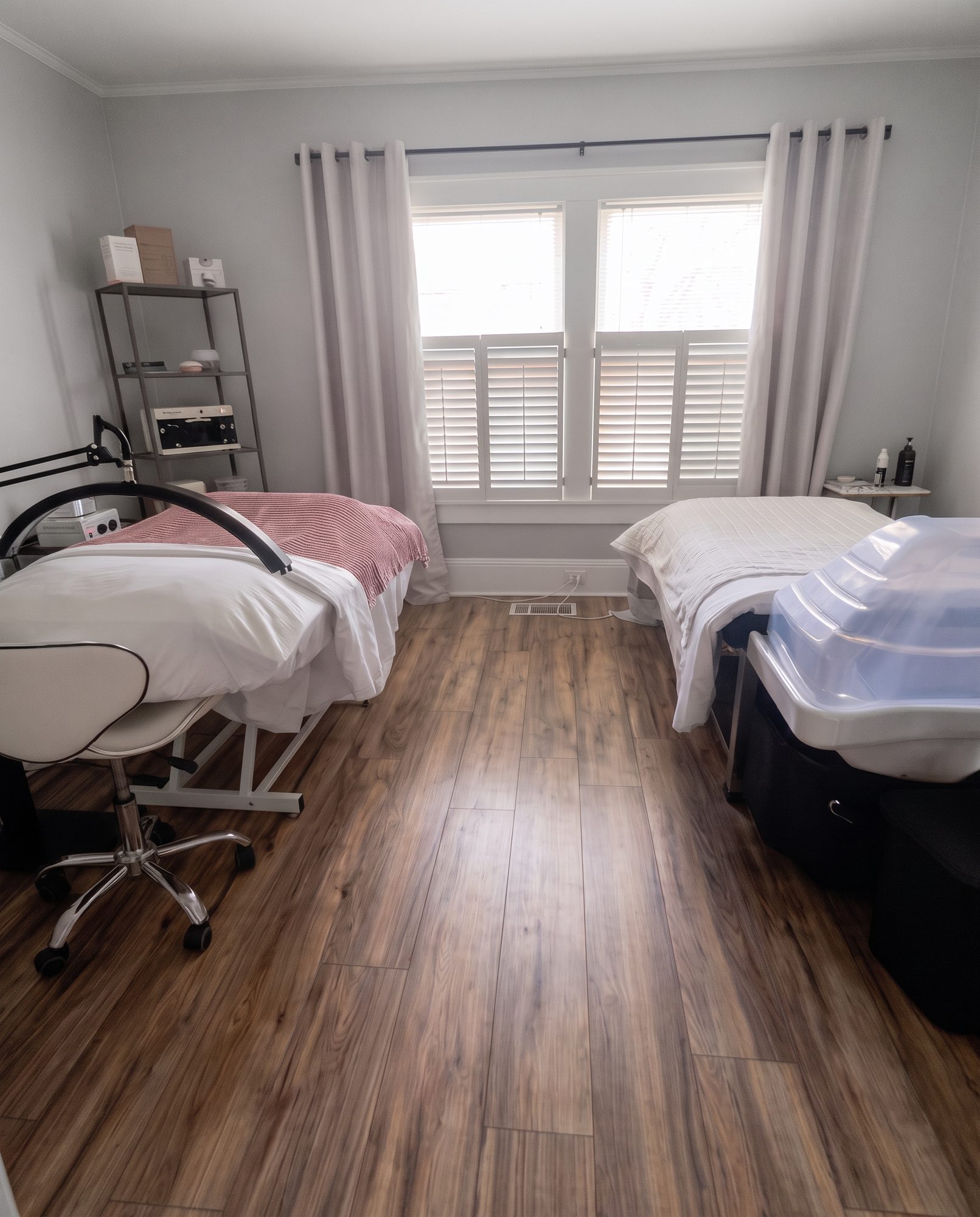 A treatment room, two tables either side of the shuttered window