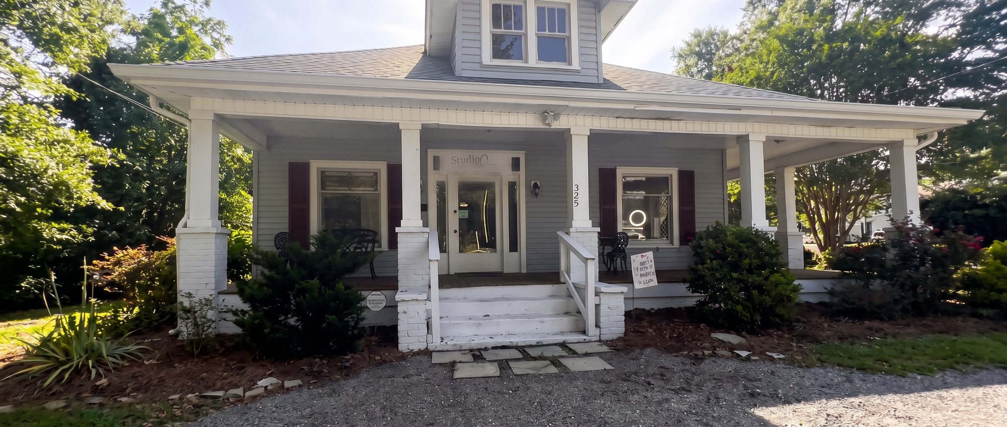 The Studio C house on Chestnut Street, wraparound porch in morning light