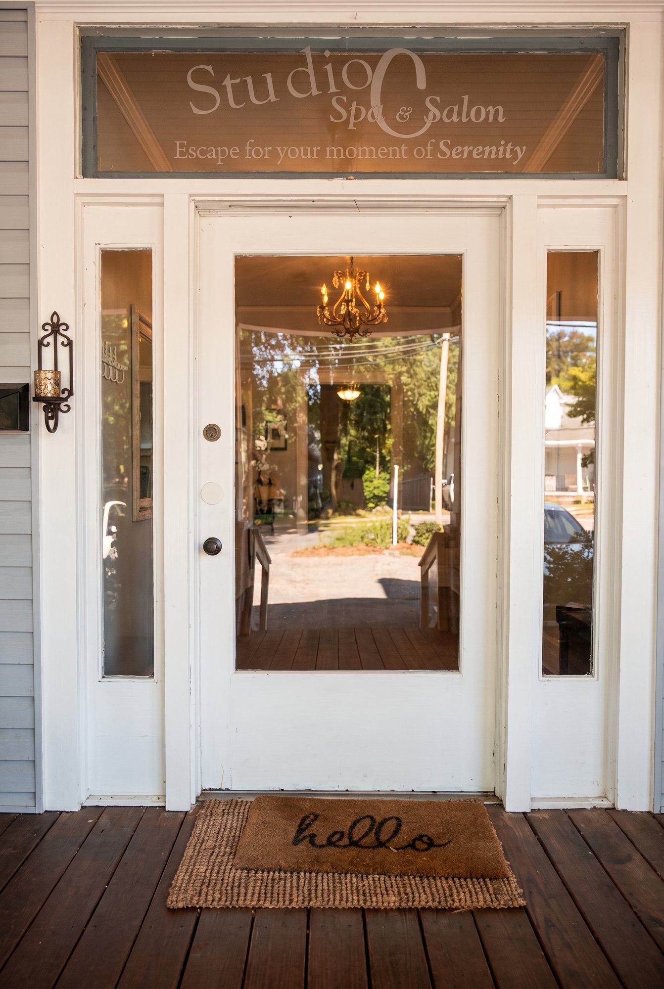 The Studio C front door, lettered glass above and a hello mat on the porch